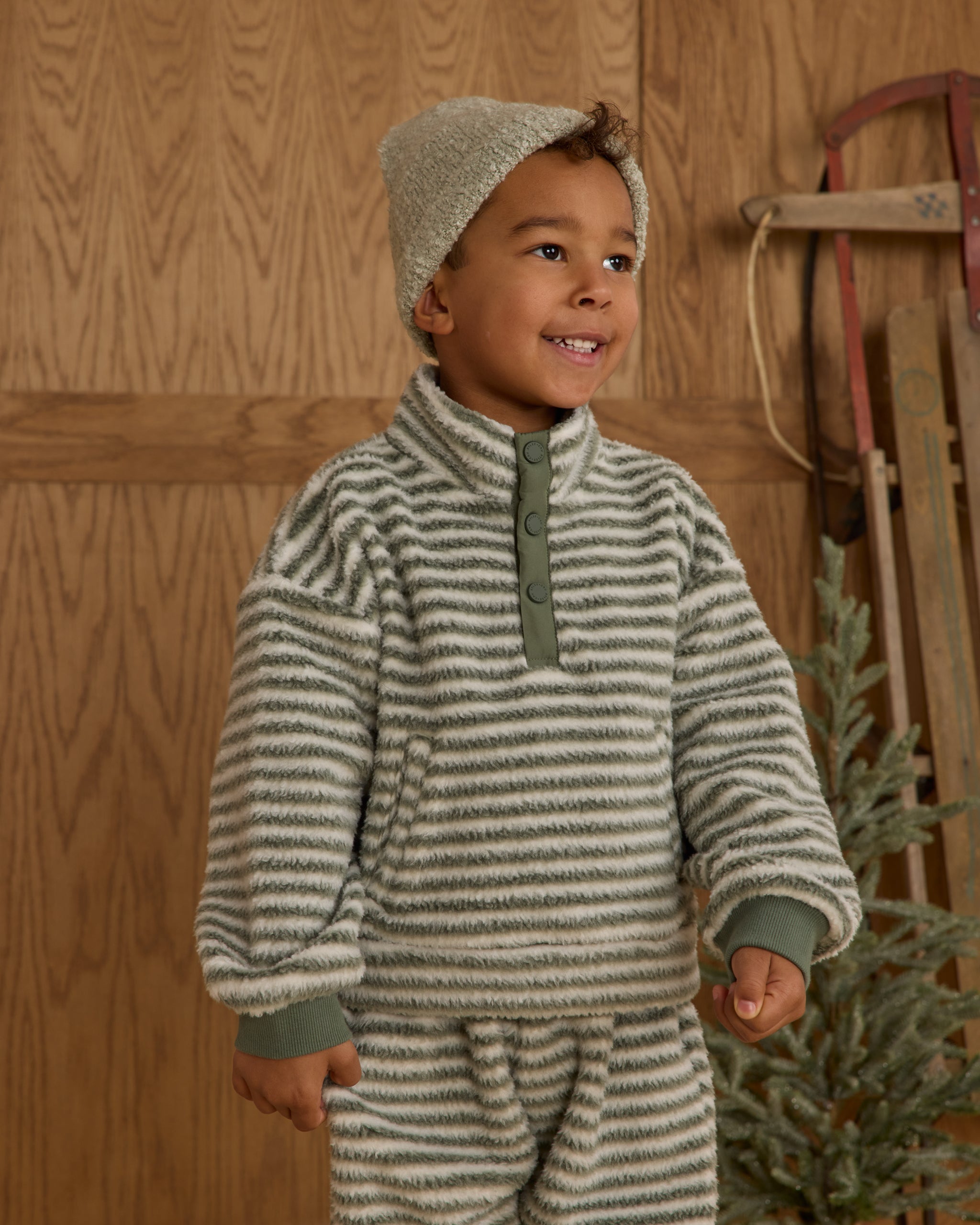 Child wearing a striped fuzzy quarter zip. 