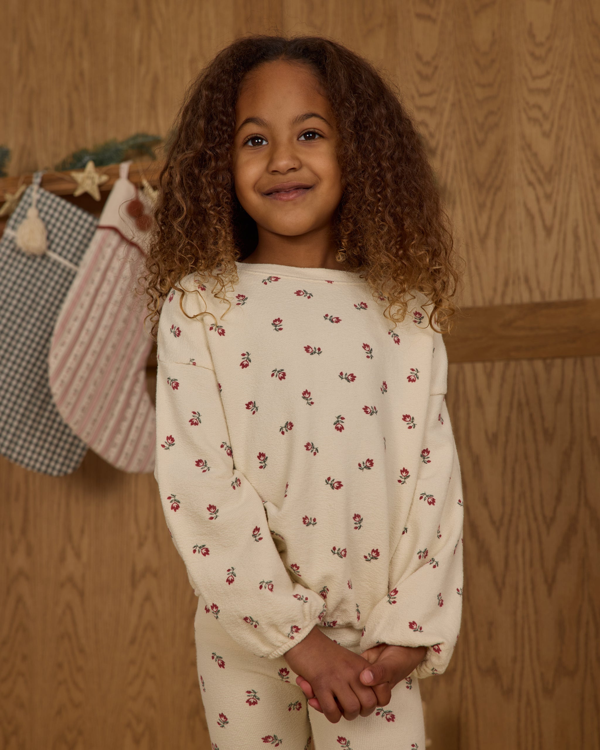 Young girl wearing a white matching set with a floral detail