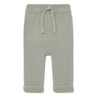 Green knitted baby pants with a drawstring on a white background