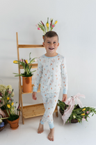 Child wearing a floral pajama set with easter prints and a gingham trim