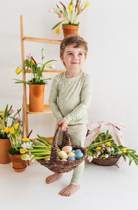 Child wearing green pajamas with a goose print