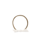Beige elastic headband with a white bow on a white background