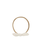 A light brown elastic headband with a small white fabric bow at the front, shown on a plain white background.