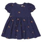 A navy blue cotton eyelet dress for toddlers, featuring short puff sleeves, a gathered waist, and an all-over embroidered pattern of small orange and yellow flowers with green leaves.