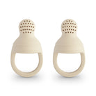 Two beige silicone baby teething rings on a white background