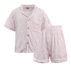 Pink pajama set with button-up top and shorts on a white background