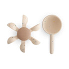 Beige spoon and bowl bath toy set with speckled pattern on a white background