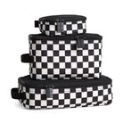 Set of three black and white checkered bags stacked on a white background
