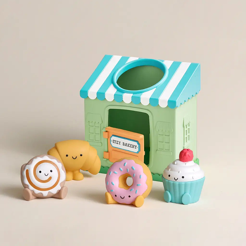 Toy set with a bakery-themed playhouse and cute character toys on a beige background