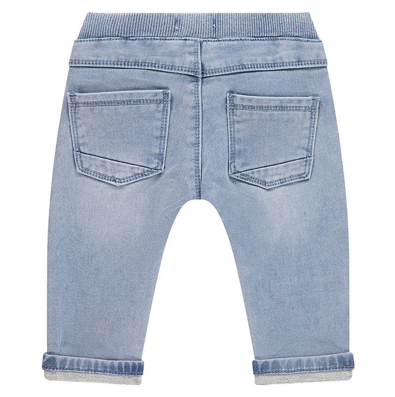 Back view of light blue denim jeans on a white background