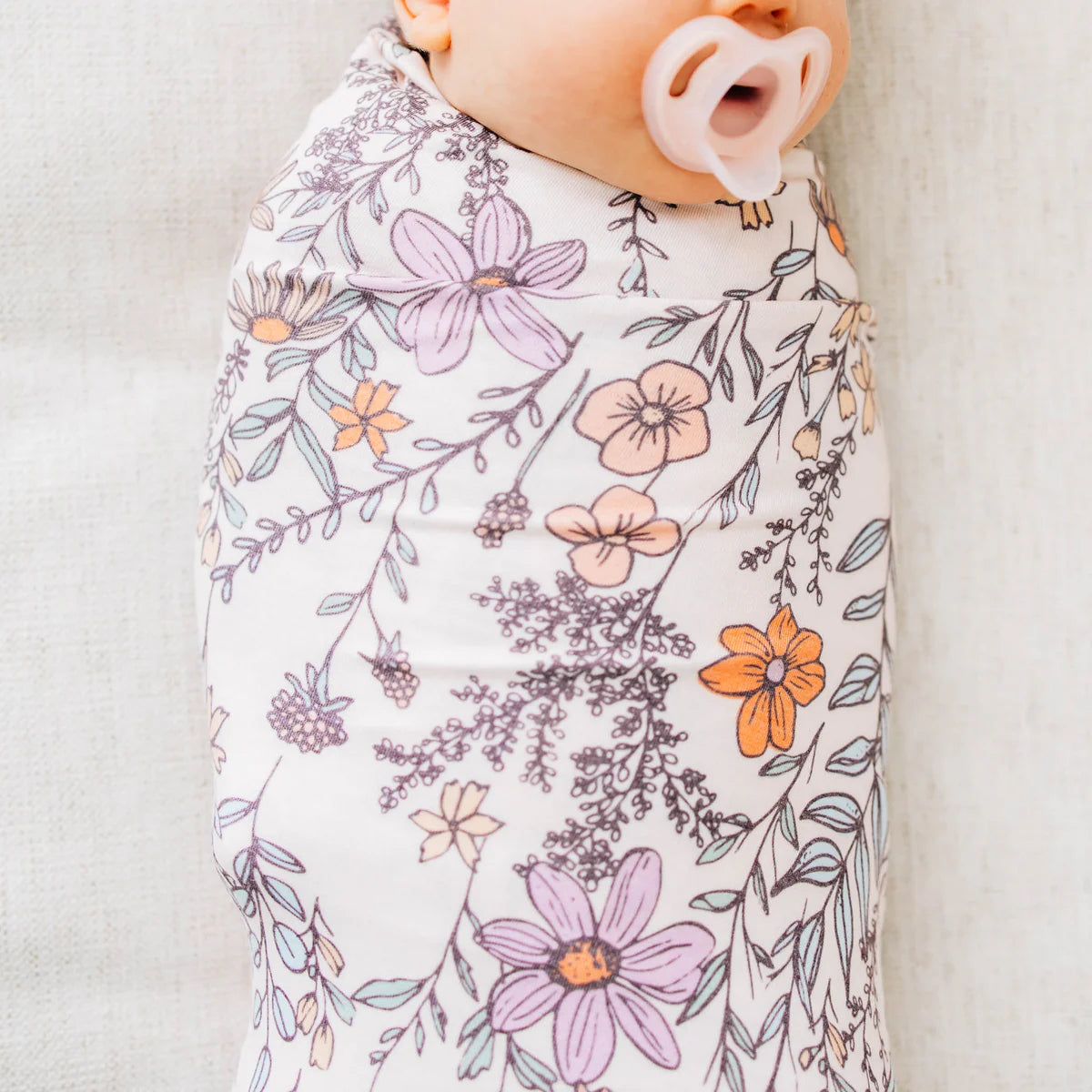 baby swaddle blanket with purple shaded floral pattern 