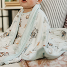 baby wearing a cowboy printed blanket