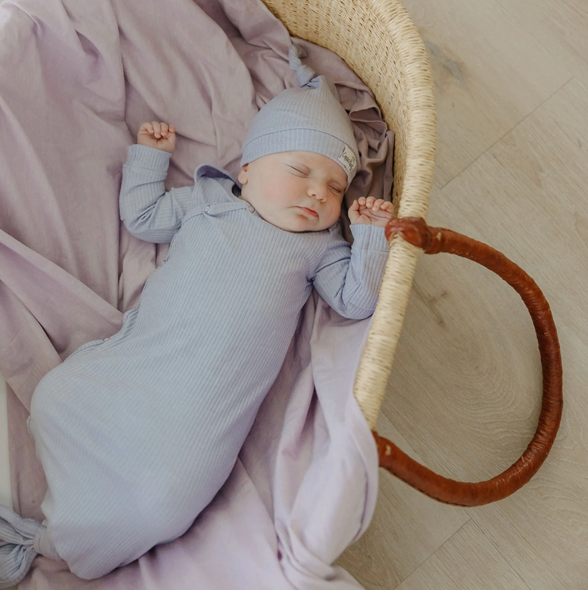 baby with matching ribbed purple knotted gown and knotted hat 