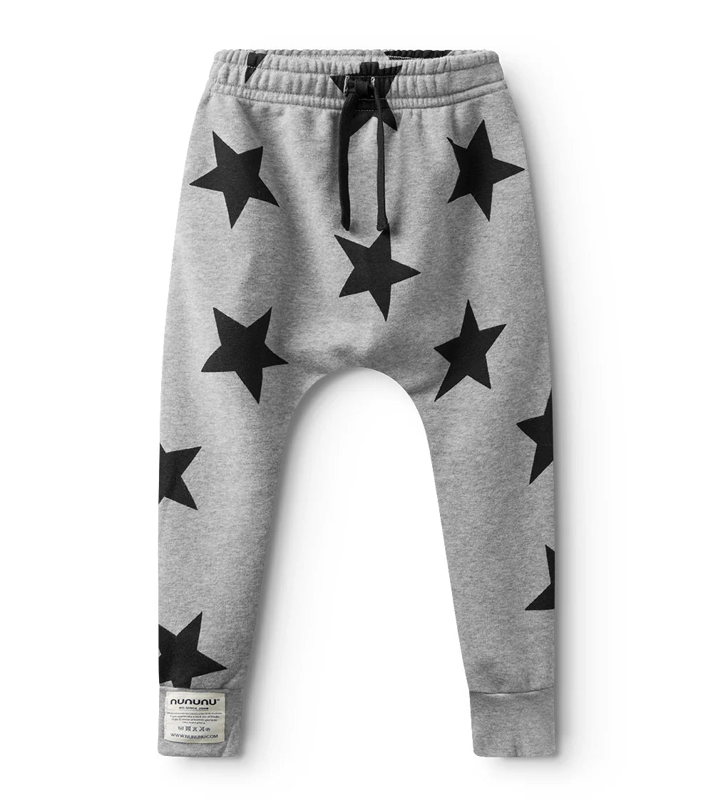 Gray sweatpants with black star patterns on a white background