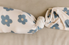 beige and black floral swaddle blanket with tie knot
