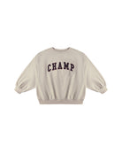Beige sweatshirt with 'CHAMP' text on a white background