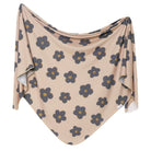 A swaddle blanket with a floral pattern in gemma color, draped and spread out.