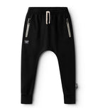 Black harem pants with zippers on a white background