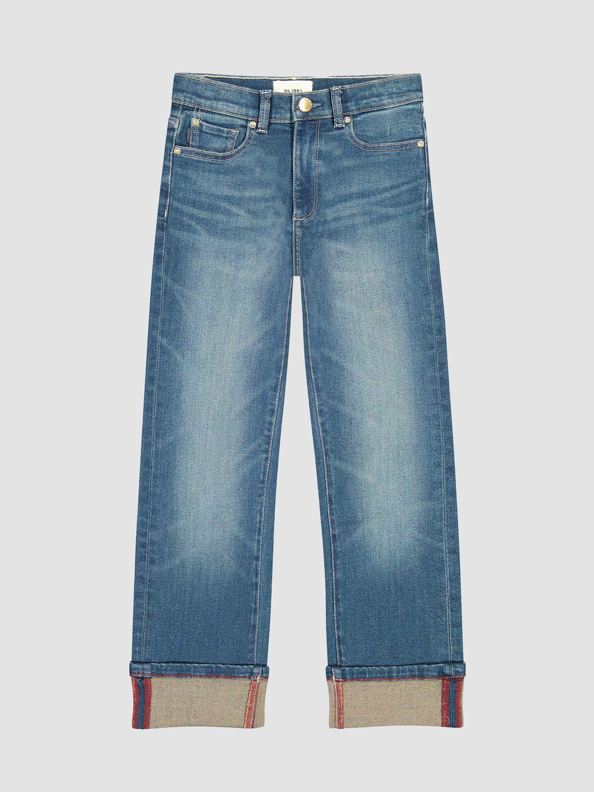 Blue jeans with cuffed hems on a light gray background
