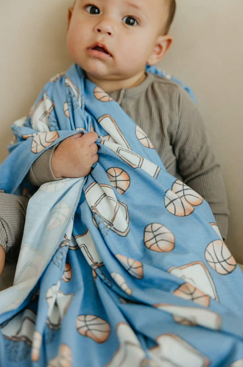 blue swaddle blanket for babies with basketball themed print 