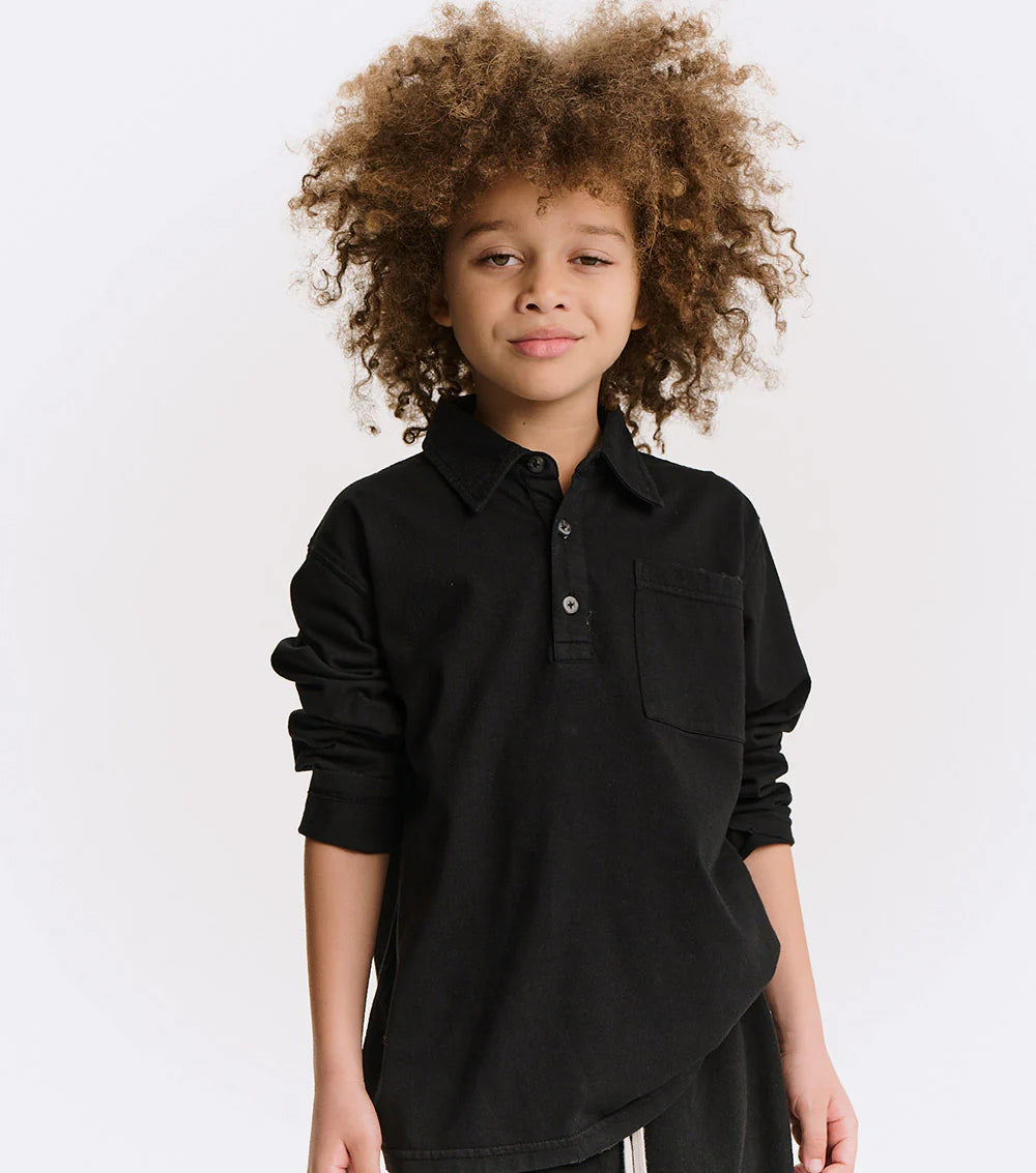 Child wearing a black shirt against a white background