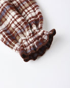 Plaid burgundy patterned fabric on a white background