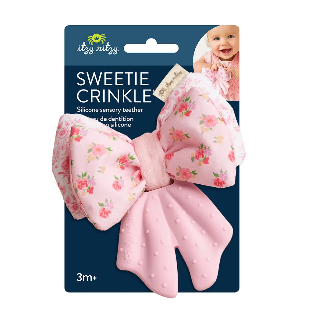 Pink crinkle teether with floral pattern on its packaging, featuring the brand 'itzy ritzy'.