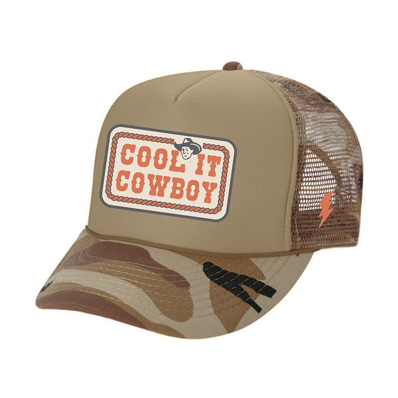Camouflage baseball cap with 'Cool It Cowboy' patch on a white background