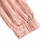 cinched bottom of pink cargo pants 
