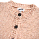 Close-up of a pink knitted cardigan with black buttons and Molo label.