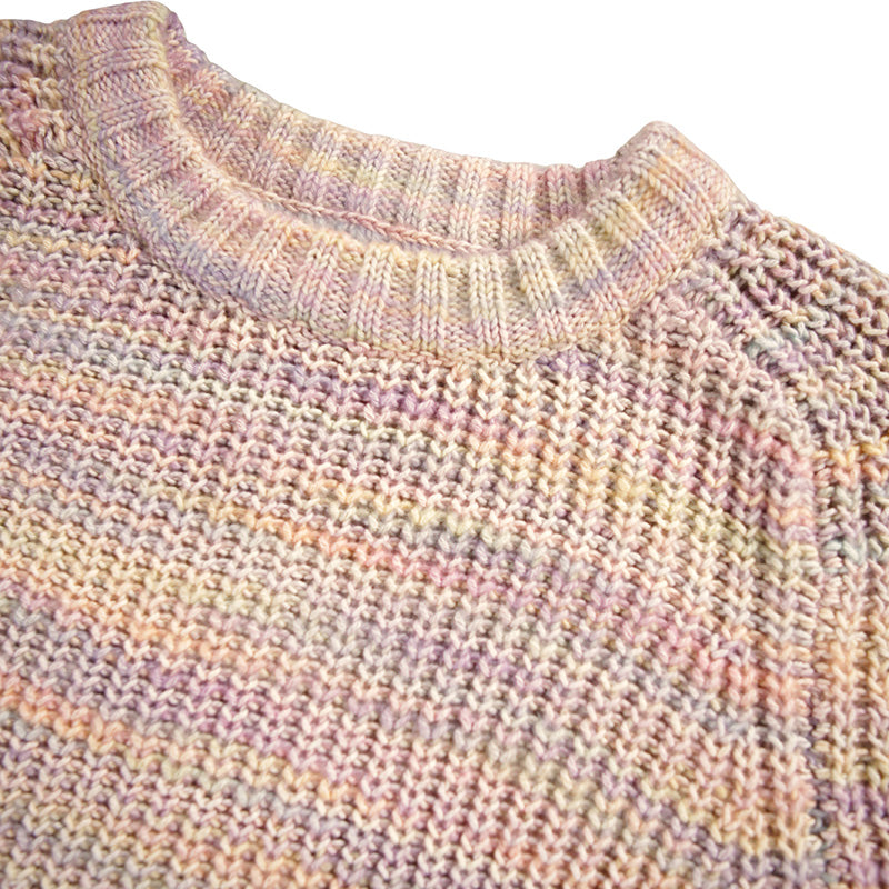Close-up of a knitted sweater with a multicolored pattern on a white background