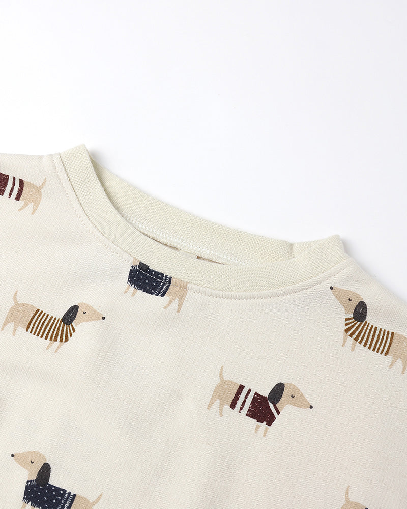 close up of beige crewneck with wiener dogs on a white background 
