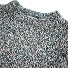 Close-up of a textured green and beige fabric with a collar.