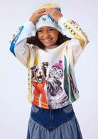 Child wearing a colorful hoodie with animal prints on a white background
