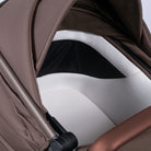 Close-up of a brown and beige baby stroller seat 