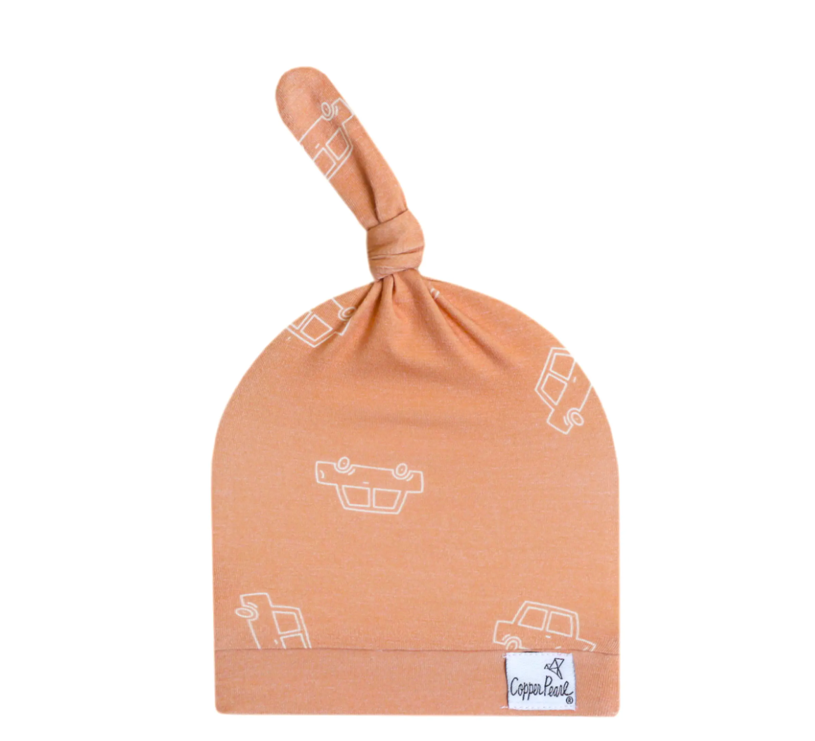 A copper-colored top knot hat with a pattern of cars on it, made from a premium stretchy fabric with an adjustable knot.