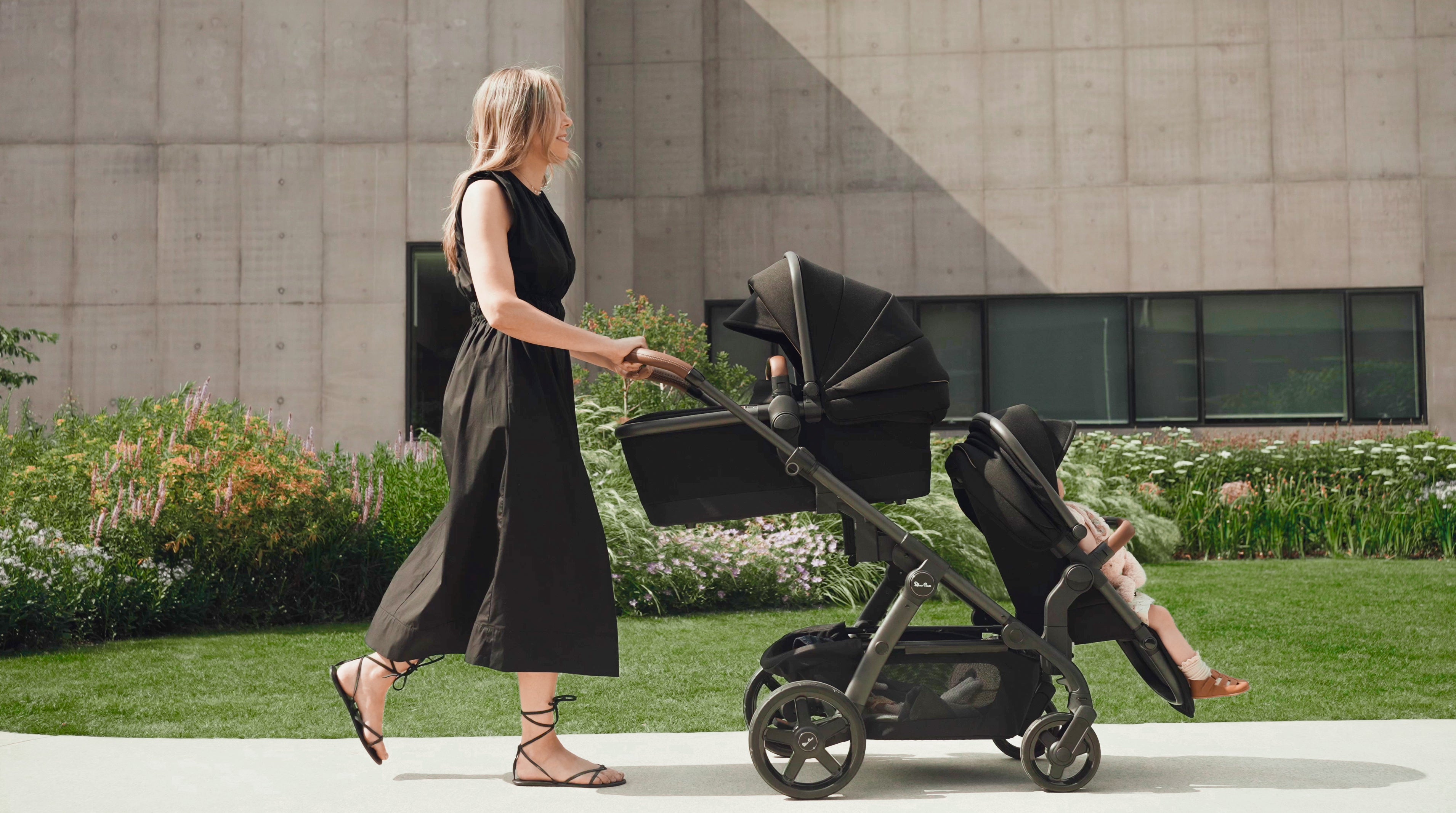 Mom out for a walk pushing luxury stroller 