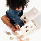 kid playing with shape sorter