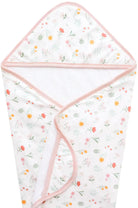 A knit hooded towel with a floral pattern and a pink border, laid flat.