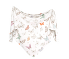 A knit swaddle blanket with a pattern of colorful butterflies on a white background, draped and twisted at the edges.