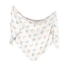 A knit swaddle blanket with a geometric pattern featuring bicycles in multiple colors on a white background.