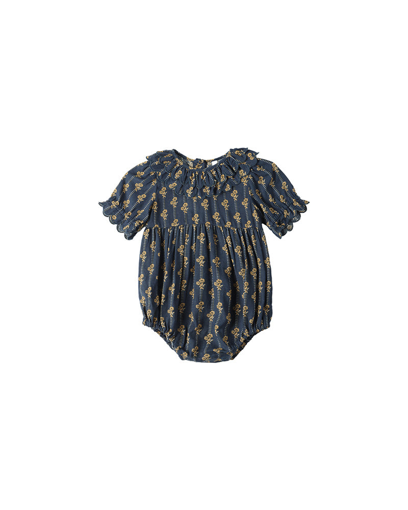 Navy blue baby romper with gold floral pattern on a white background
