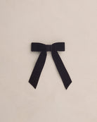 Black bow on a beige background