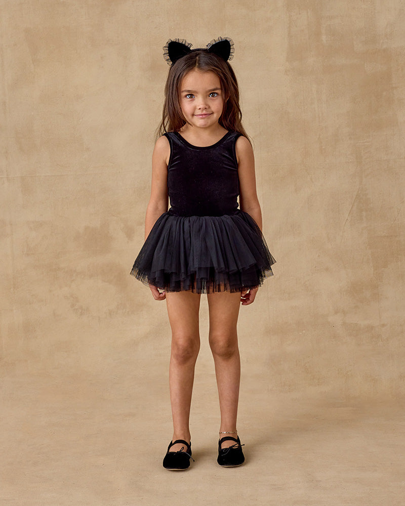 Young girl in a black velvet leotard with a layered tulle tutu