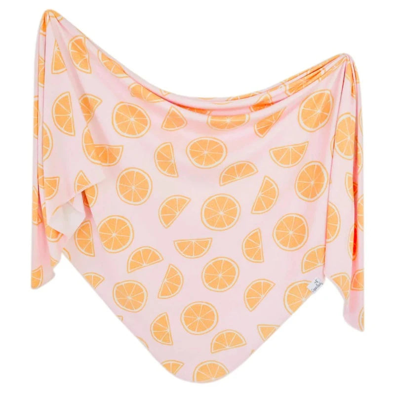 pink swaddle blanket with orange fruit print 