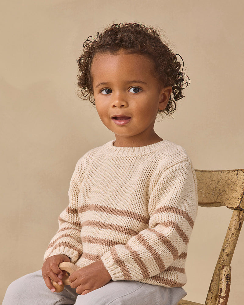 A cream-colored knit sweater with horizontal brown stripes across the chest and sleeves, displayed flat against a solid white background.