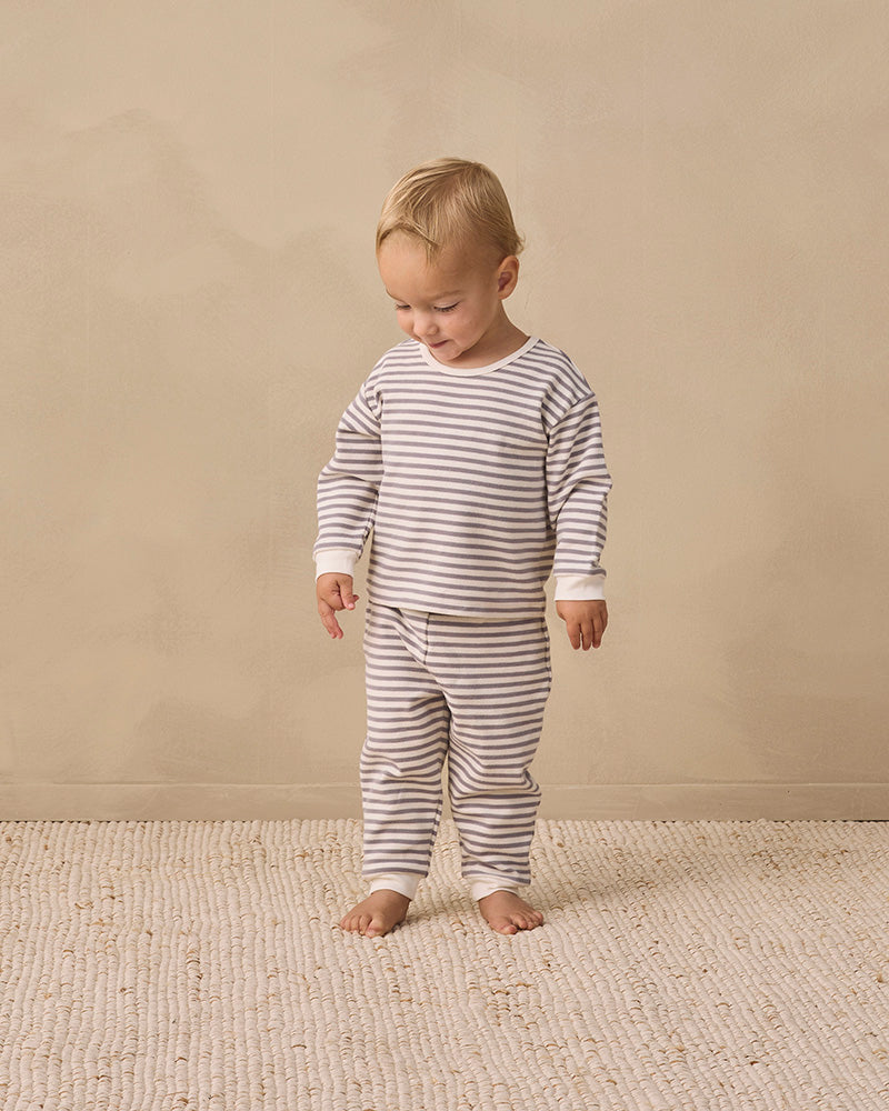 A two-piece children's outfit set featuring a long-sleeve top and matching pants, both with horizontal gray and off-white stripes, laid flat on a white background.