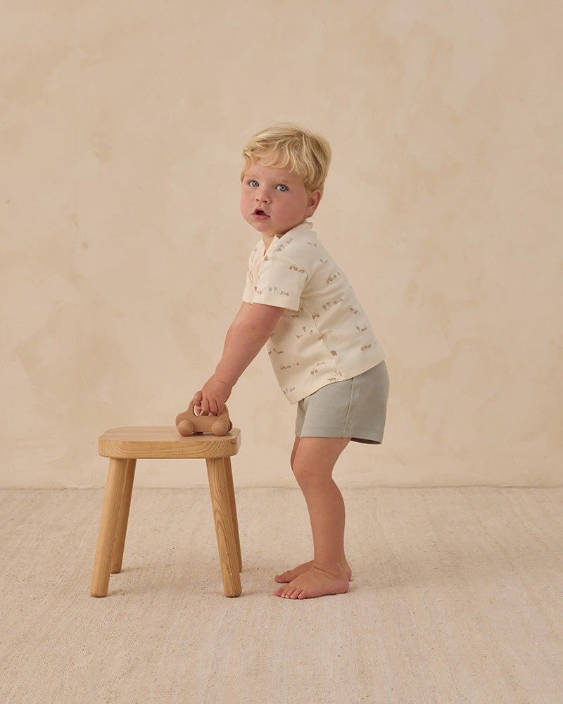 Child wearing a white boxy tee with small farm prints
