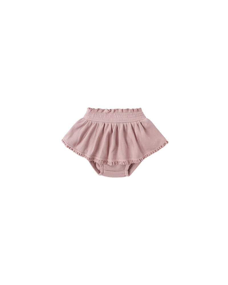 Pink ruffle baby bloomers on a white background