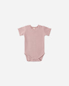Pink baby bodysuit with ruffled collar on a white background